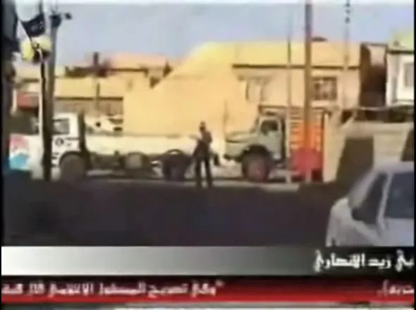 A Mujahidin Shura Council (MSC) insurgent stands at his post on a street in Ramadi.