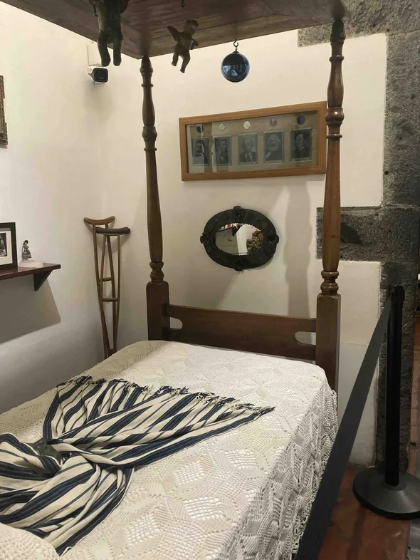 Figure 1. Death mask of Frida Kahlo with photographs of Stalin, Engels, Lenin, Marx, and Mao on wall opposite. Frida Kahlo house museum in Mexico City. Photo by author.
