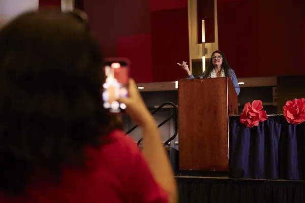Nicholas-Weber-Rashida-Speaking-Member-Records-on-Phone-1024x683