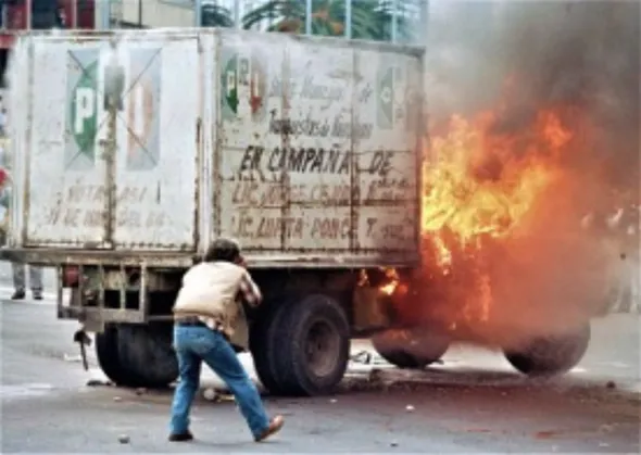 Mexico 1988: Candidate Carlos Salinas de Gortari of the Institutional Revolutionary Party (PRI) won in what appeared to be a fraudulent election. As seen in this photo, people responded to the fraudulence with a wave of violence and discontent that eroded the state’s legitimacy, paving the way for further democratization.