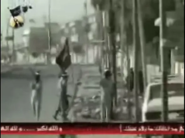 Mujahidin Shura Council insurgents patrol the streets of Ramadi under an MSC banner.