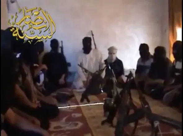 Ansar al-Sunnah insurgents listen to a sermon from their commander.